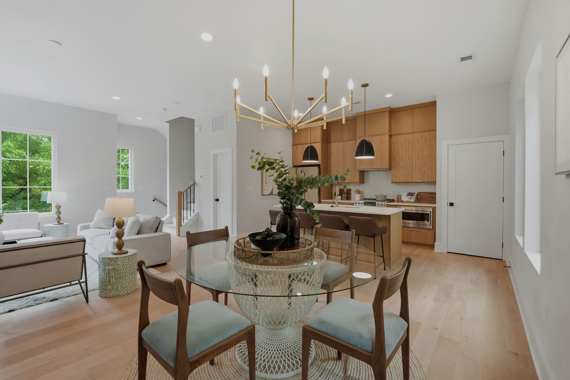The main living level at 604 E 16th Street: dining, kitchen island and living room in one open space