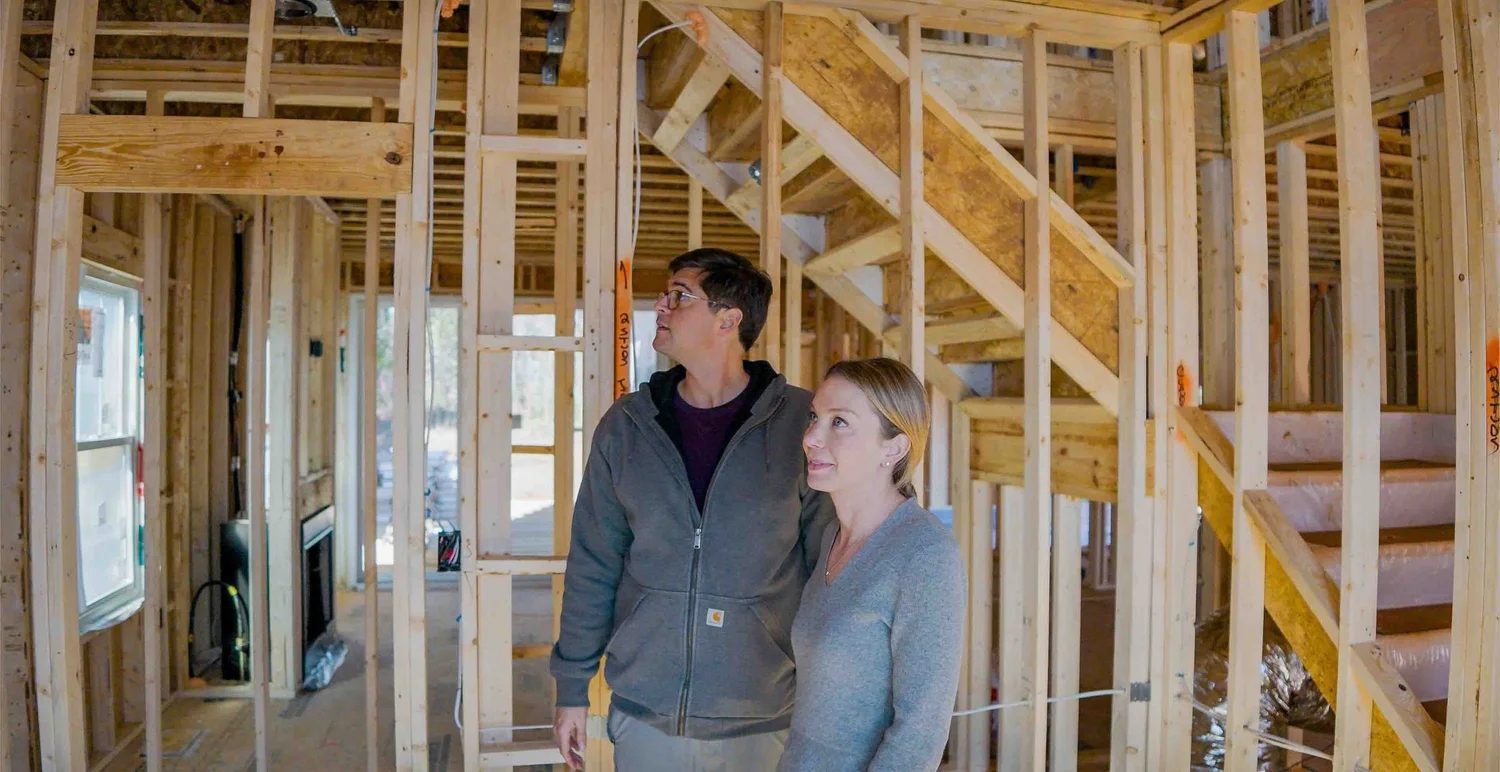 Connor and Kate Murphy walking a house in framing
